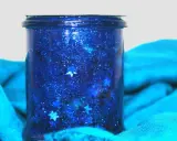 Barattolo della calma fai da te con glitter blu e stelline, un piccolo universo scintillante per rilassarsi.