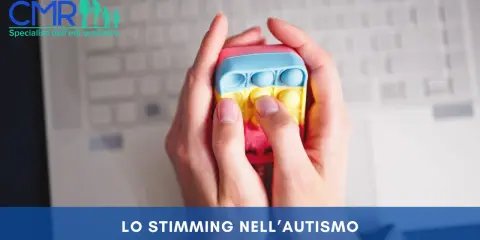 Mani che premono un giocattolo pop-it colorato, un esempio di stimming cos'è, utile per l'autismo.