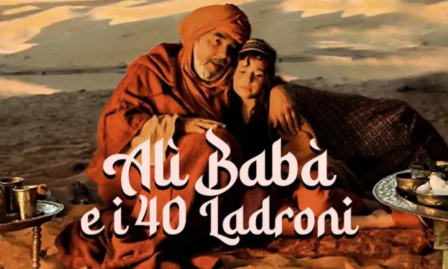 Alì Babà, con un bambino tra le braccia, seduto nel deserto. La scritta "Alì Babà e i 40 ladroni" campeggia sull'immagine.