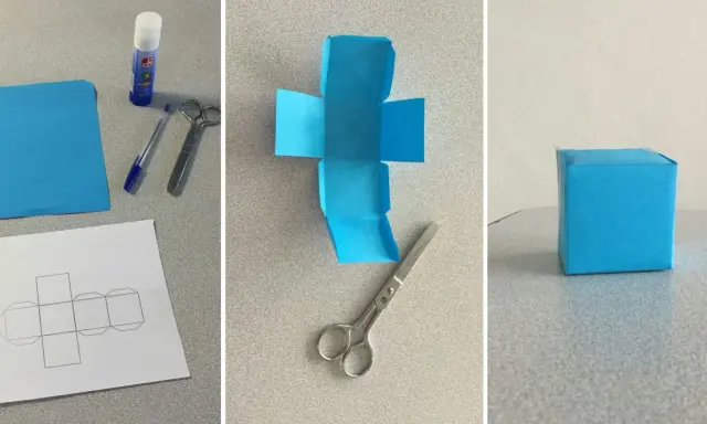 Creazione di un cubo fai da te: carta blu, forbici, colla e modello per un progetto creativo.